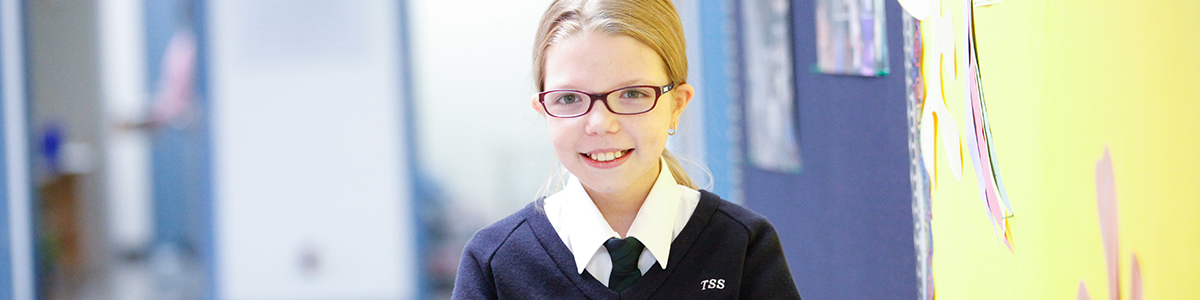 TSS girl smiling in hallway